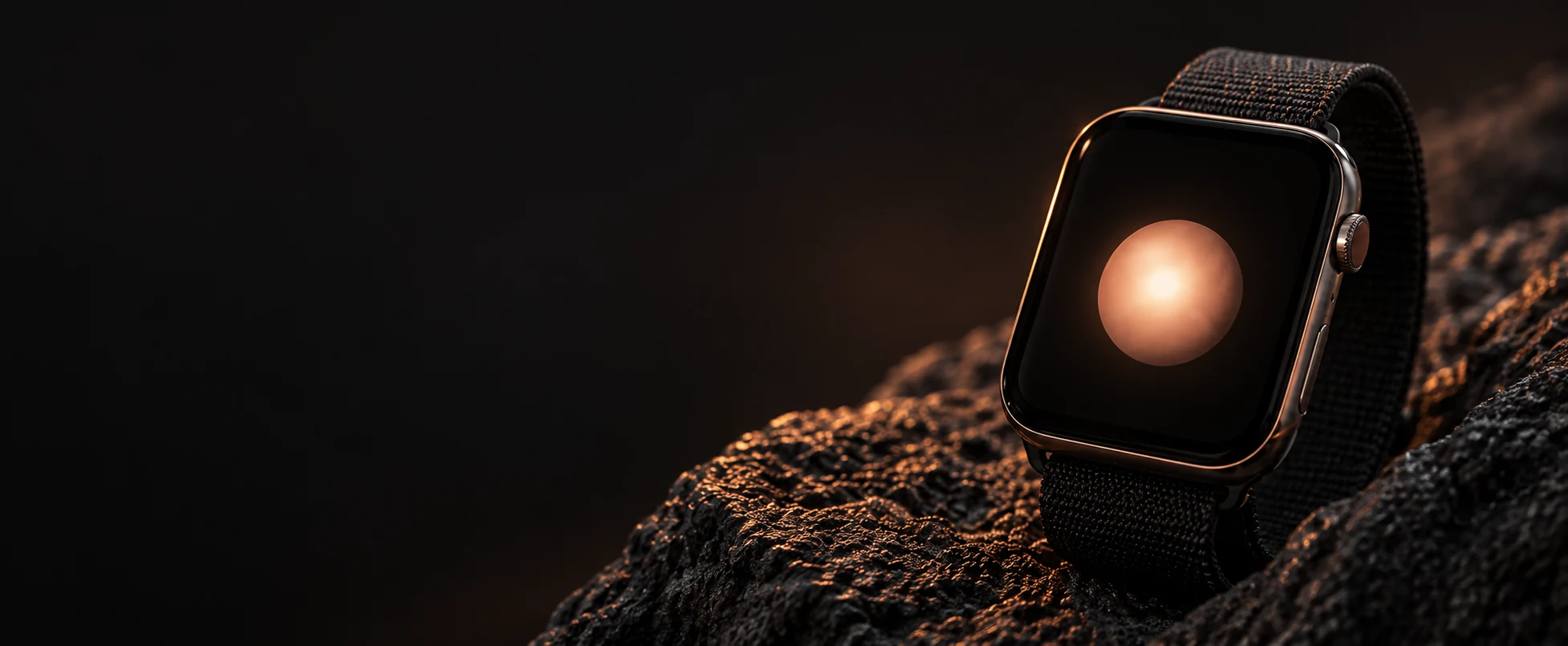 Apple Watch resting on dark stone in warm evening light